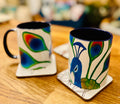Sassy peacock coffee mug with deep blue handle and interior